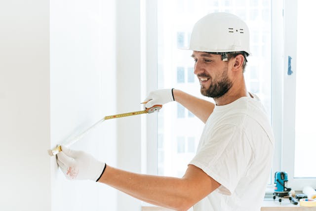 a%20contractor%20measuring%20a%20wall a%20contractor%20measuring%20a%20wall